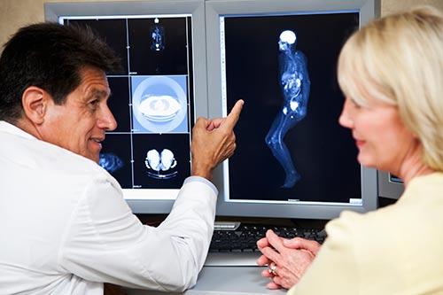 Radiologist and patient reviewing magnetic resonance images.