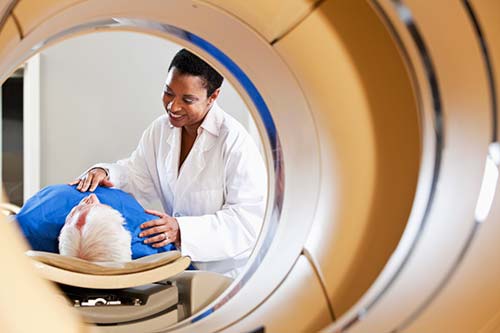 Radiologist preparing a patient for a computed tomography (CT) exam.