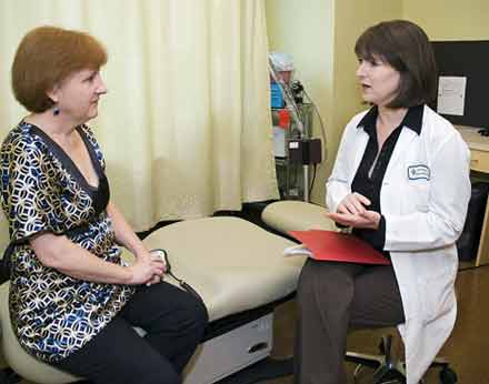 Photo of a radiologist explaining breast MRI to patient.