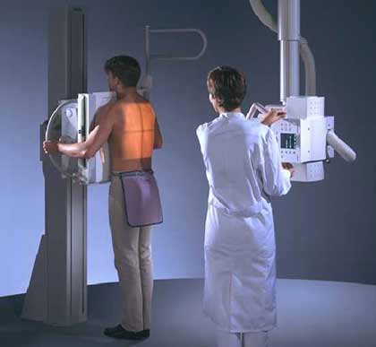 Technologist with patient undergoing chest x-ray